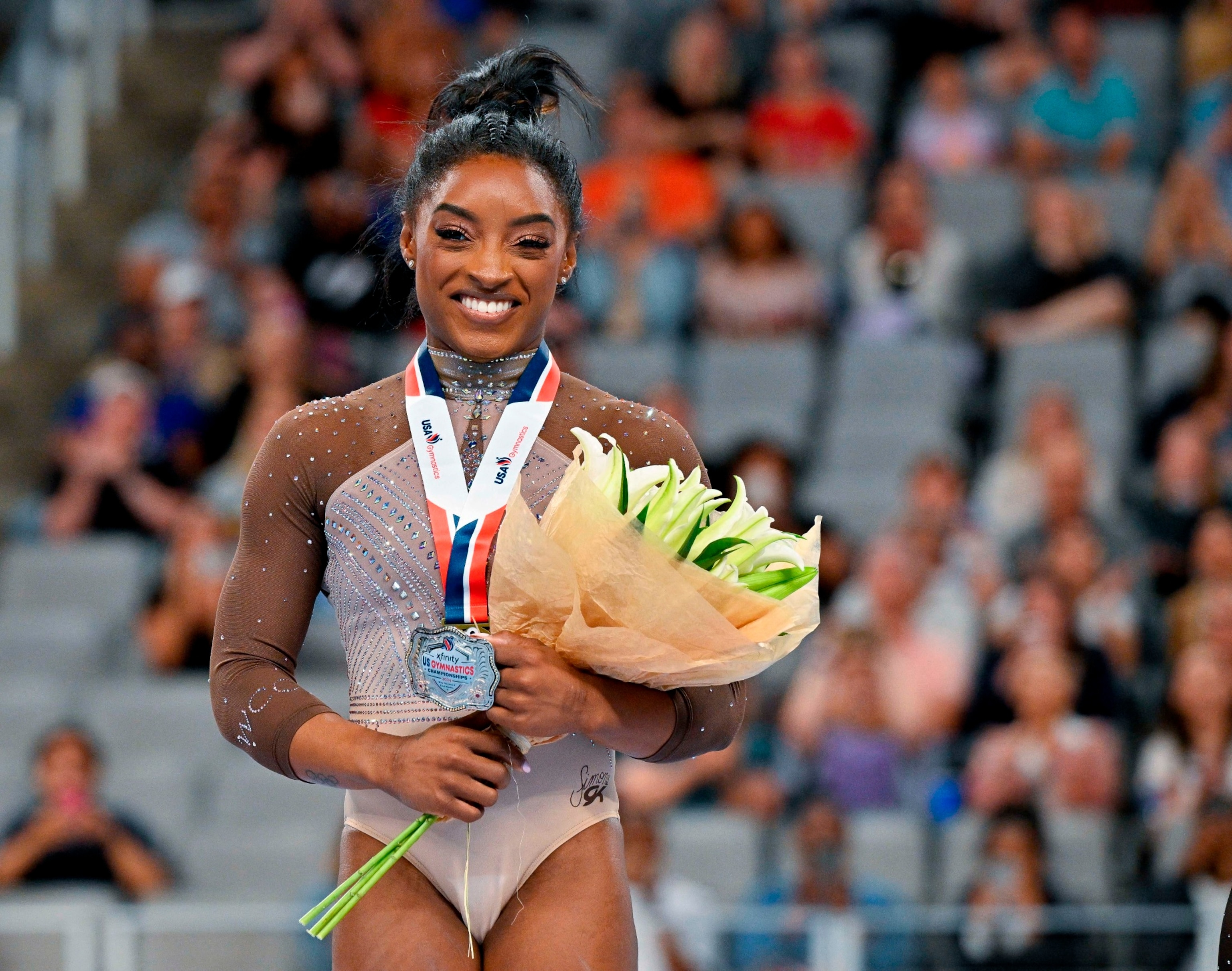 PHOTO: Simone Biles of World Champions Centre poses for a photo with her gold medal and commemorative belt buckle after finishing in first women's 2024 Xfinity U.S. Gymnastics Championships at Dickies Arena on Jun 2, 2024 in Fort Worth, Texas.