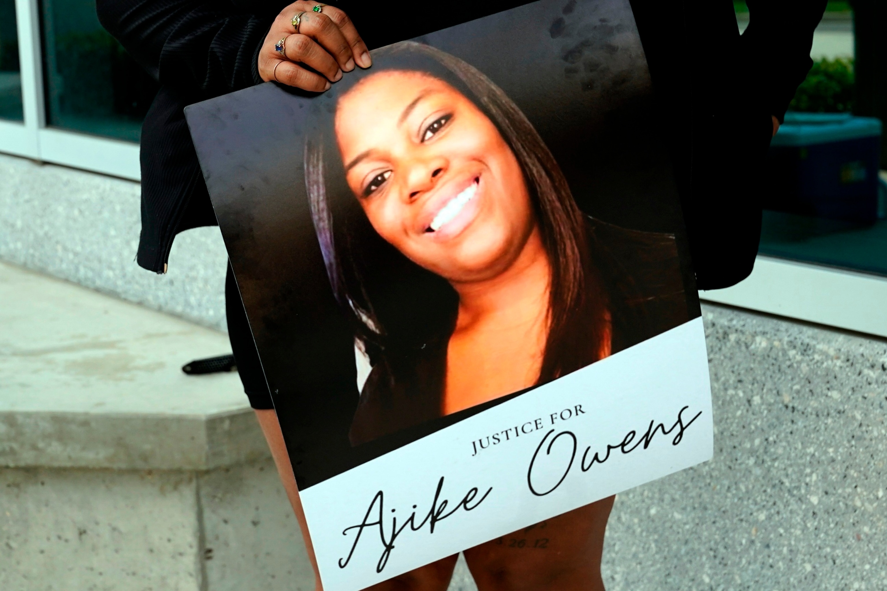 PHOTO: In this June 6, 2023, file photo, a protester holds a poster of Ajike Owens at the Marion County Courthouse, in Ocala, Fla., demanding the arrest of a woman who shot and killed Owens, a 35-year-old mother of four.