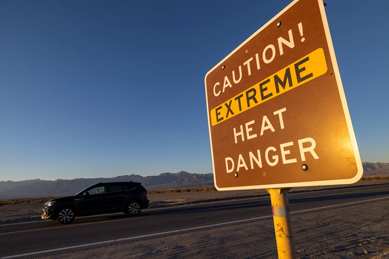 Temperatures In Death Valley National Park Could Break All Time Record
FURNACE CREEK, CALIFORNIA - JULY 15: A car passes a sign warning of extreme heat danger on the eve of a day that could set a new world heat record in Death Valley National Park on July 15, 2023 near Furnace Creek, California. Weather forecasts for tomorrow call for a high temperature of 129º Fahrenheit and possibly as high as 131. Previously, the highest temperature reliably recorded on Earth was 129.2F (54C) in Death Valley in 2013. A century earlier a high temperature in Death Valley reportedly reached 134F but many modern weather experts have rejected that claim along with other high summer temperatures reported in the region that year. (Photo by David McNew/Getty Images)