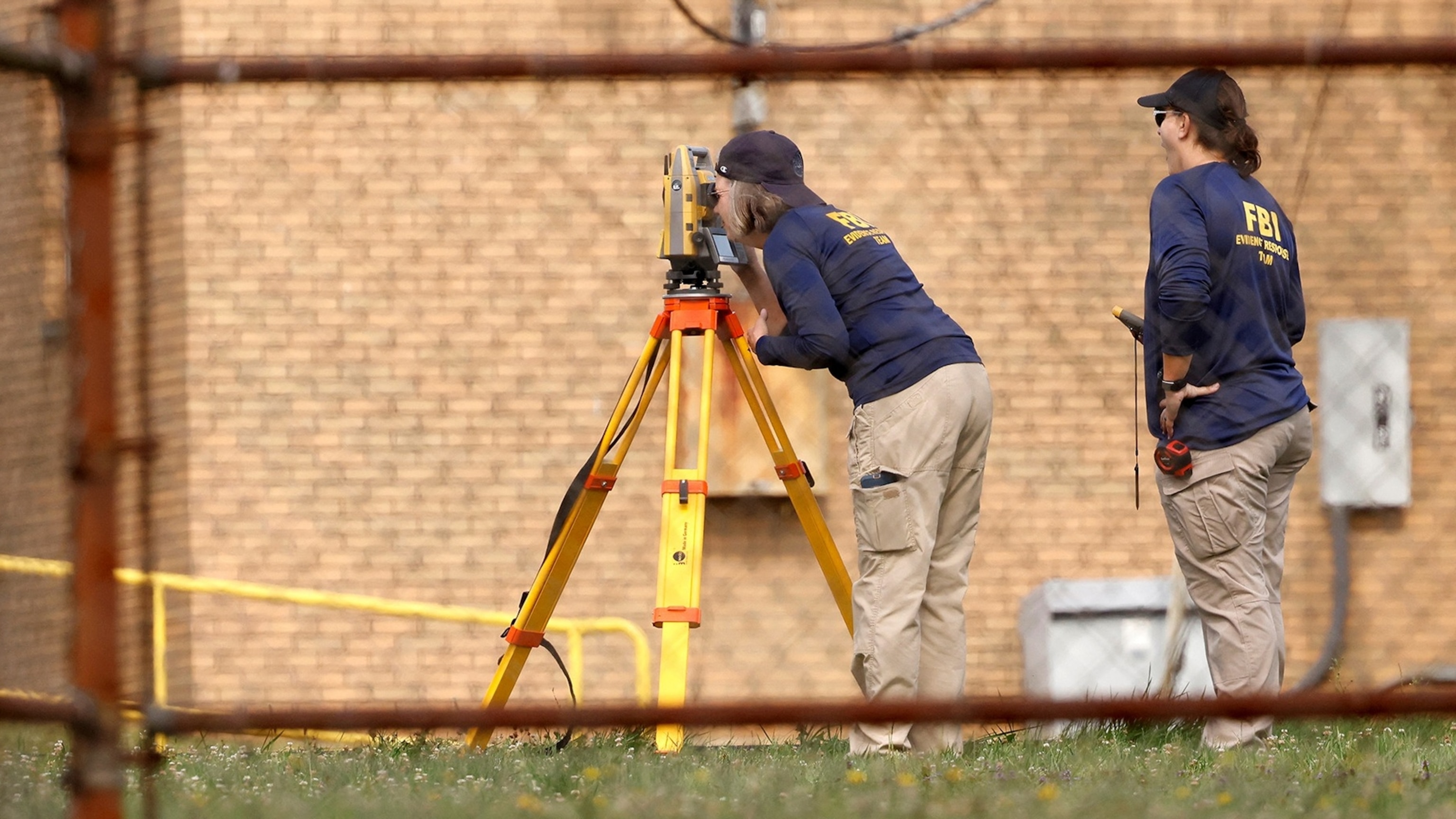 PHOTO: Members of the FBI Evidence Response Team, work near the building where a gunman was shot dead by law enforcement, in Butler, Pa., on July 15, 2024. 