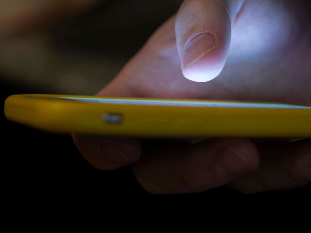 PHOTO: A man uses a cell phone in New Orleans, Aug. 11, 2019. People in crisis and those trying to help them will have a new three-digit number, 988, to reach the national suicide prevention network starting in July. 