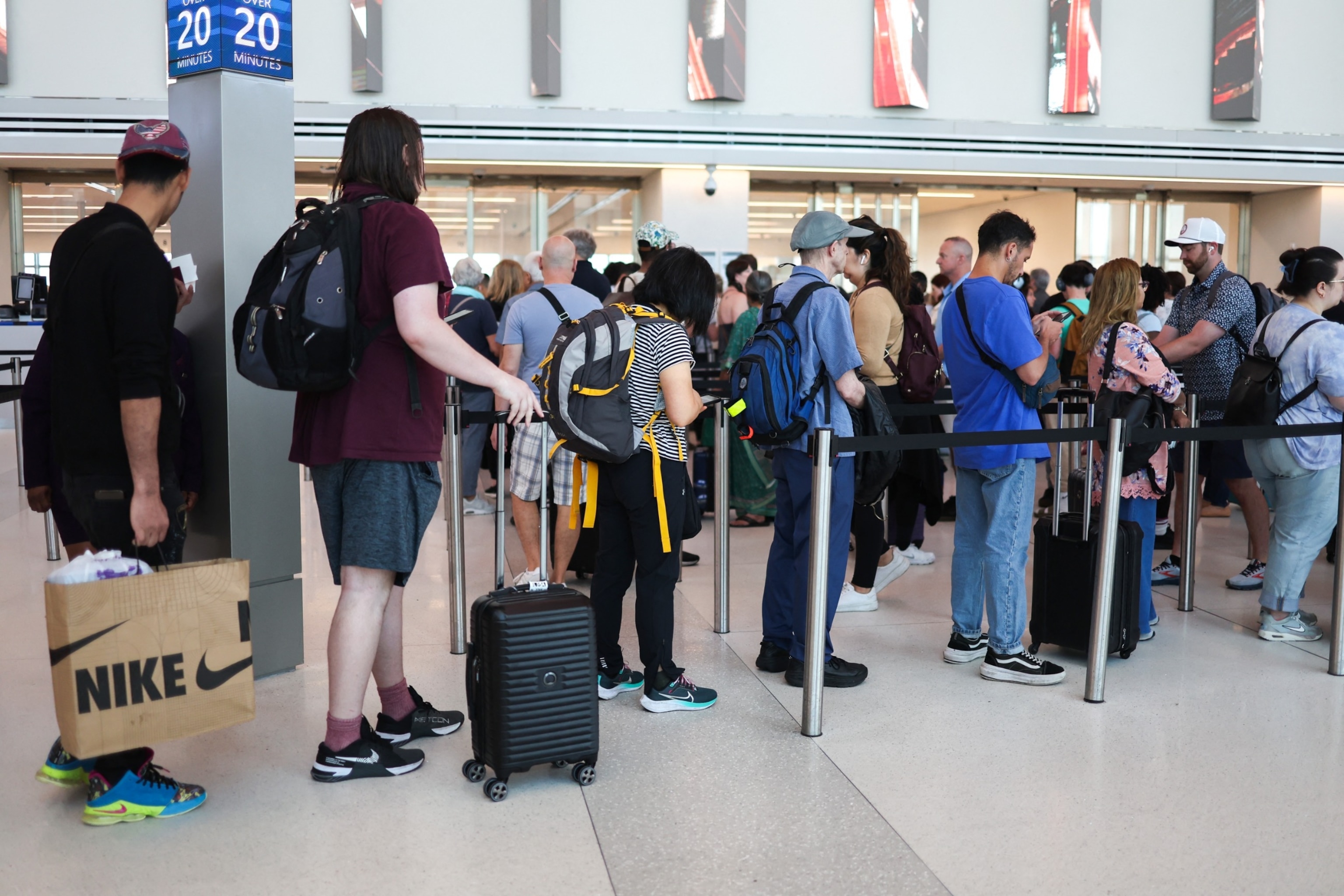 PHOTO: Passengers arrive at security gates of La Guardia airport during Memorial weekend in the Queens borough of New York City, May 24, 2024. 