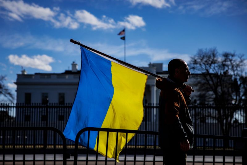 WASHINGTON, DC - FEBRUARY 25: A man with a Ukrainian flag stands on Pennsylvania Avenue in front of the White House as demonstrators gather to protest the Russian invasion on February 25, 2022 in Washington, DC. Russian President Vladimir Putin launched a full-scale invasion of Ukraine on February 24th. (Photo by Samuel Corum/Getty Images)