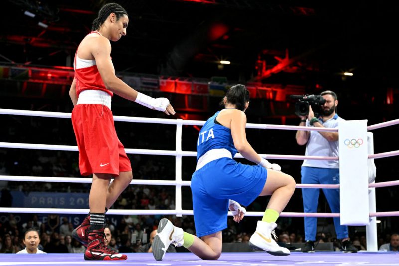 Algeria's Imane Khelif (in red) gestures to Italy's Angela Carini in the women's 66kg preliminaries round of 16 boxing match during the Paris 2024 Olympic Games at the North Paris Arena, in Villepinte on August 1, 2024. (Photo by MOHD RASFAN / AFP) (Photo by MOHD RASFAN/AFP via Getty Images)