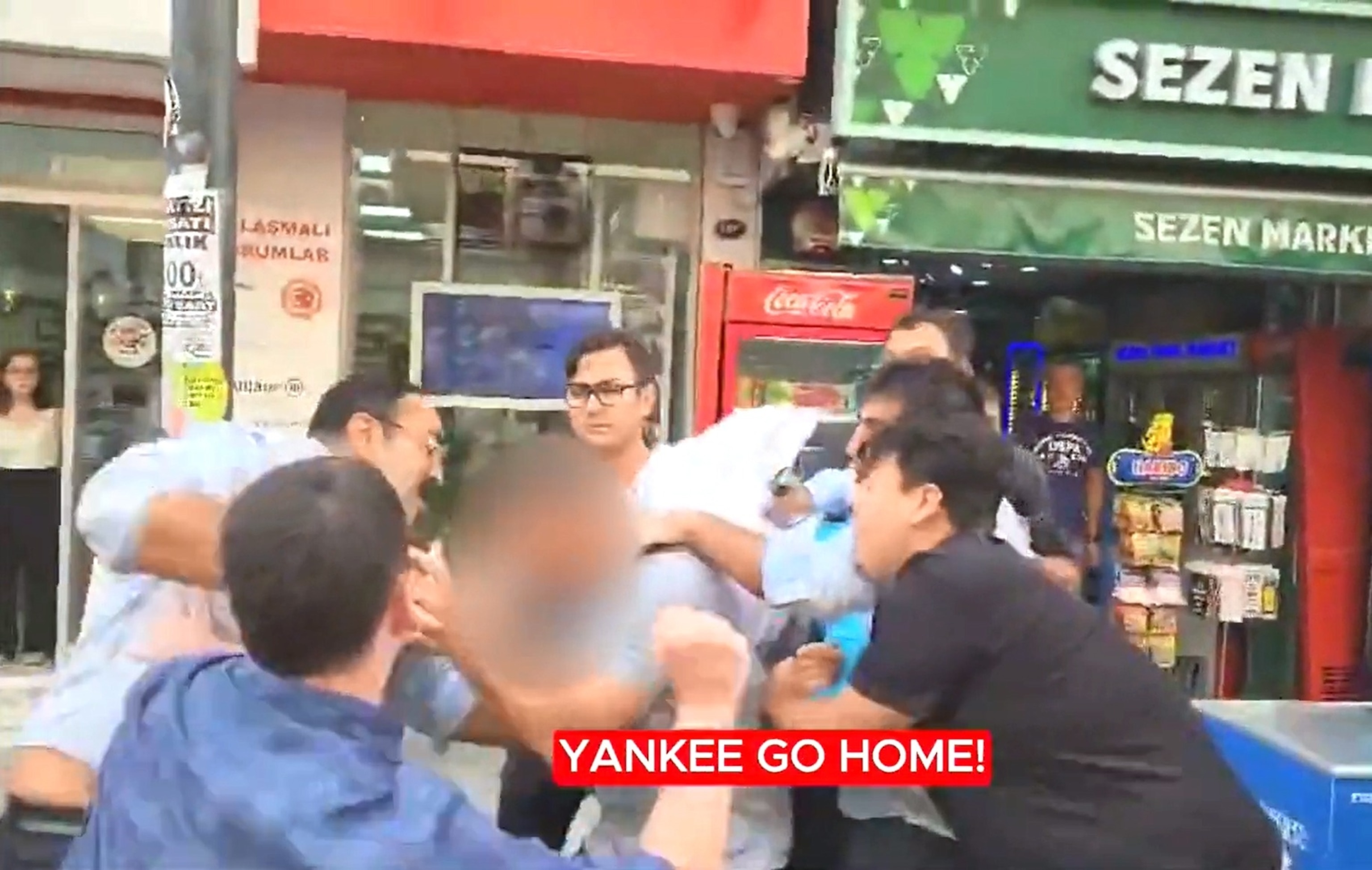 PHOTO: In this screen grab from a video posted by the Turkish Youth Union, multiple people are shown assaulting 2 service members, using a bag to cover one of the service members' head, while chanting "Yankee go home."