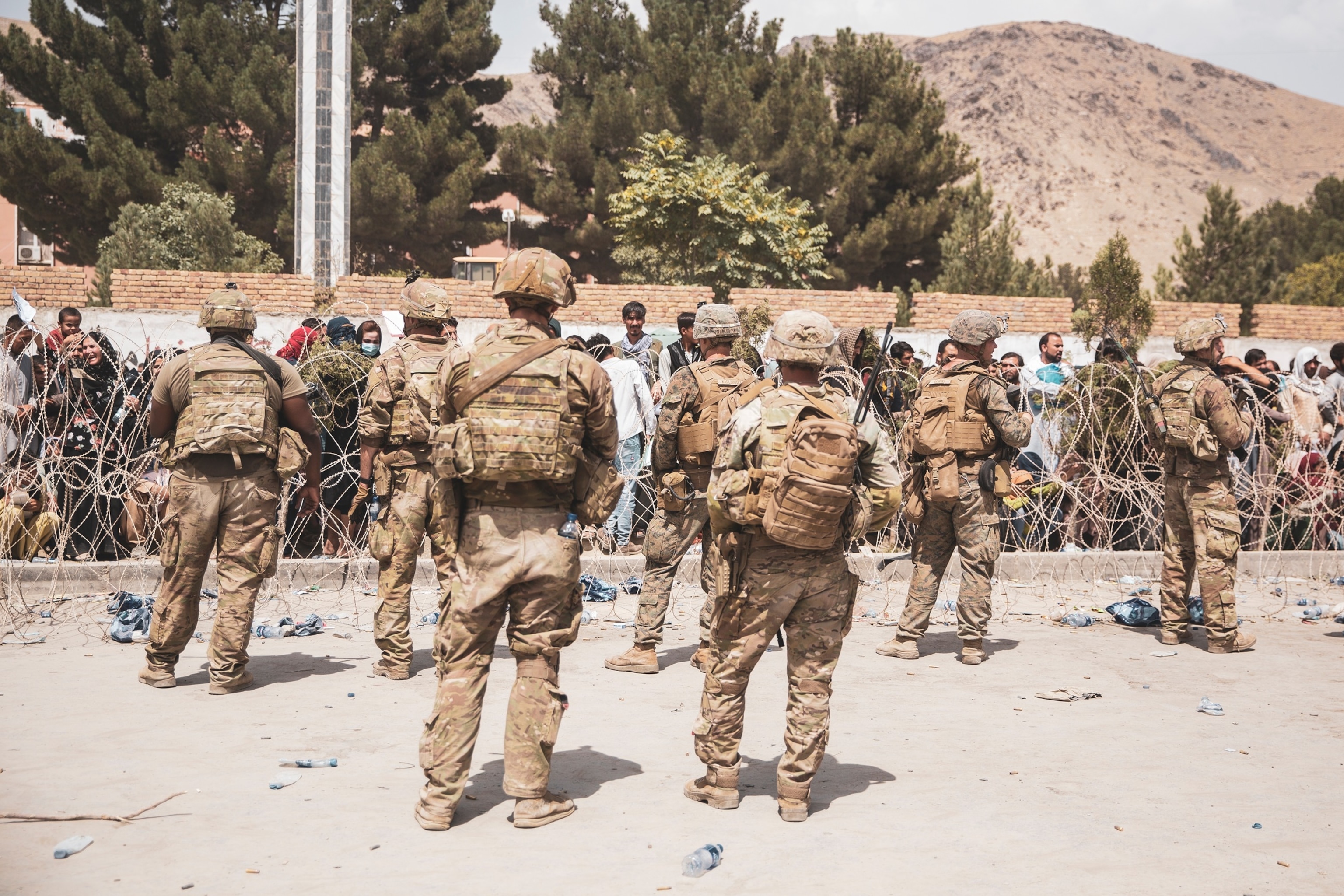 PHOTO: \This handout image shows U.S. Soldiers and Marines assist with security at an Evacuation Control Checkpoint during an evacuation at Hamid Karzai International Airport in Kabul, Afghanistan, Aug. 19, 2021. 