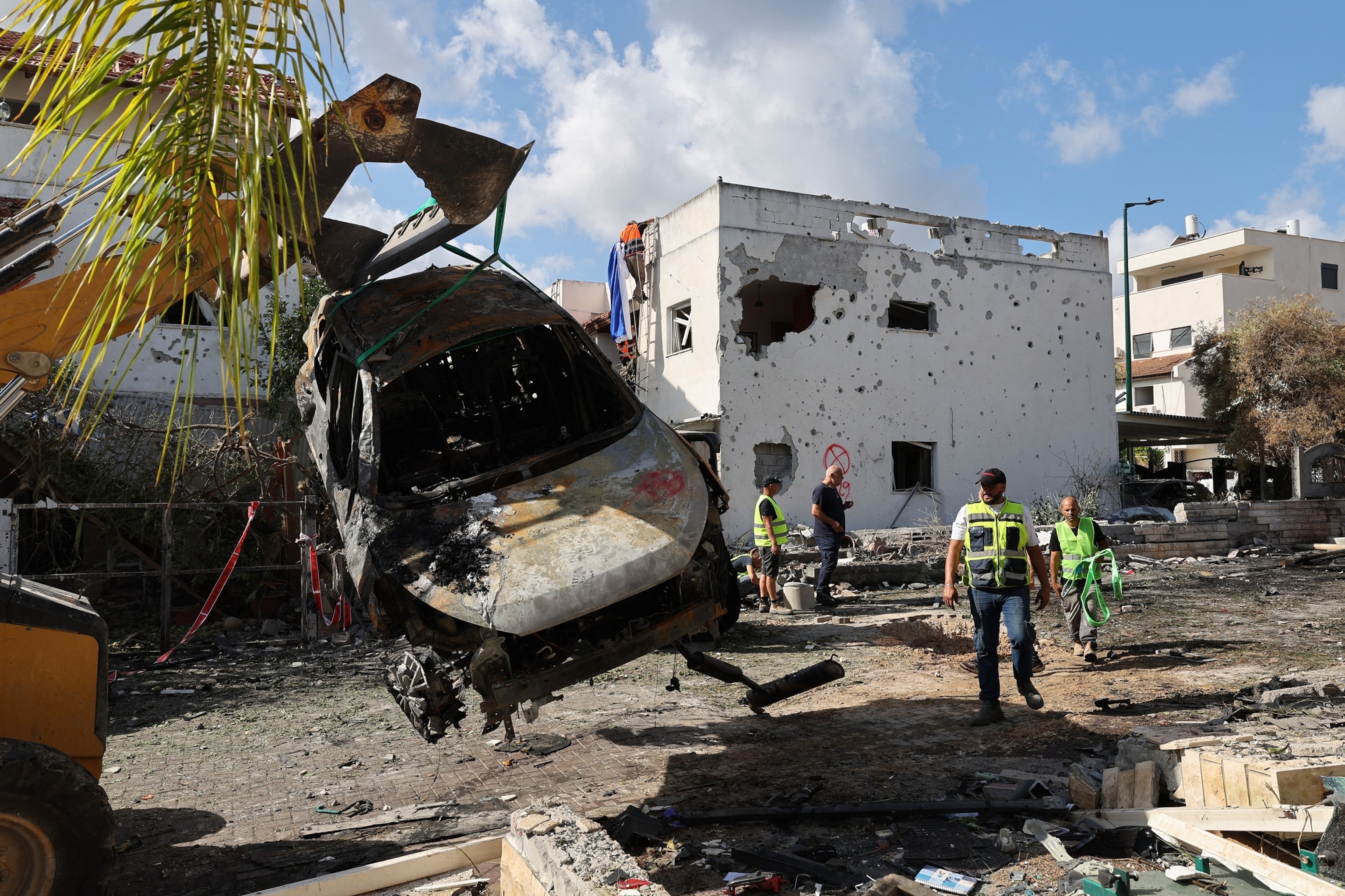 PHOTO: An excavator removes a charred car at the scene of a strike by Lebanon's Hezbollah in Kiryat Bialik in the Haifa district of Israel on September 22, 2024.