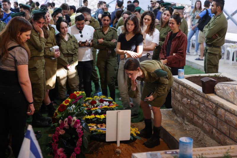 Relatives and friends mourn by the grave of Israeli soldier Eitan Itzhak Oster killed in fighting in the northern border area with Lebanon, during his funeral at the Mount Herzl Military Cemetery in Jerusalem on October 2, 2024. Confirmation of the fighting in two areas of the border came hours after Iran launched its second-ever direct attack on Israel, with the Israeli army announcing that eight soldiers have been killed so far in combat in southern Lebanon. (Photo by Ahmad GHARABLI / AFP) (Photo by AHMAD GHARABLI/AFP via Getty Images)