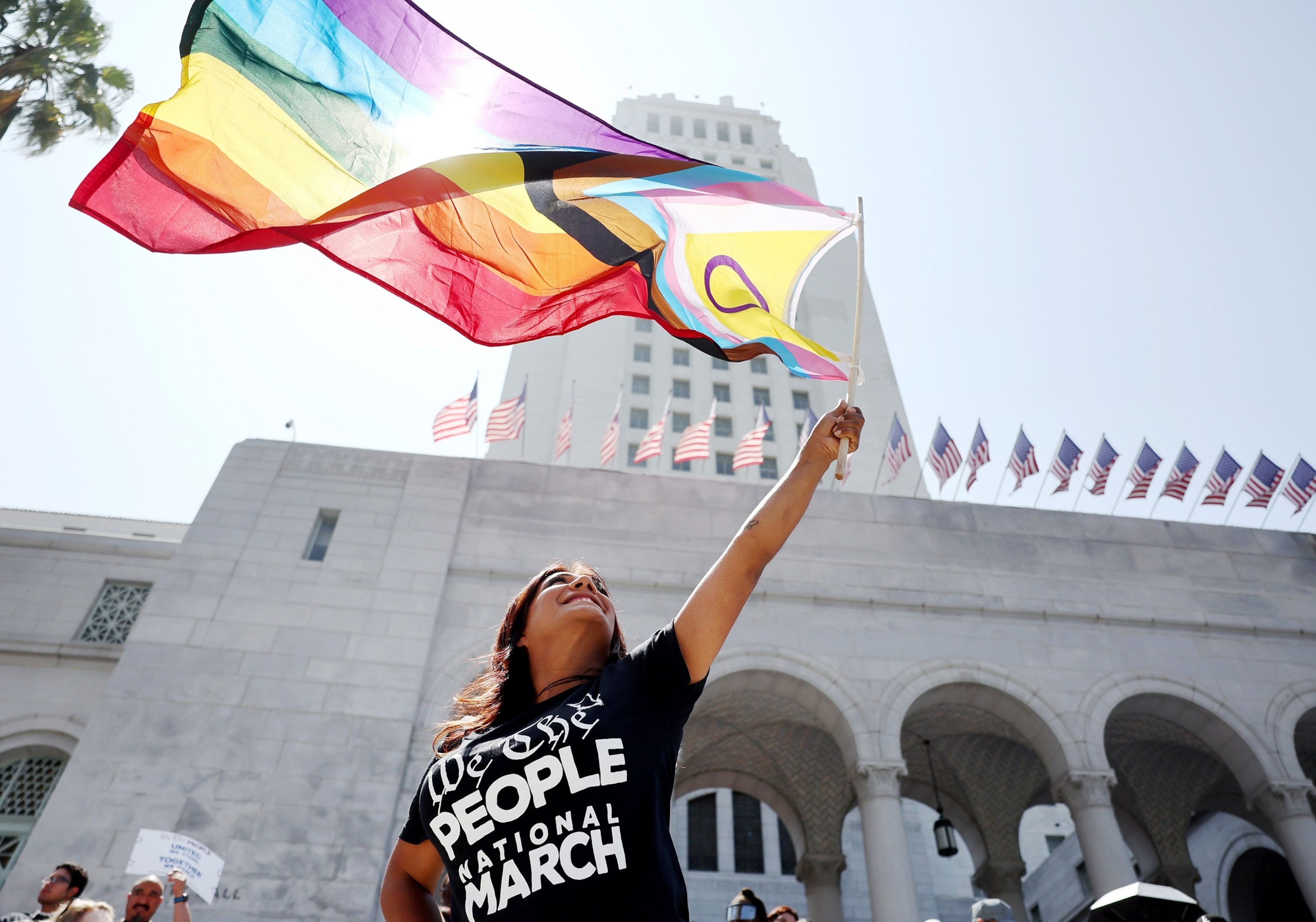 PHOTO: A demonstrator waves the intersex-inclusive Pride flag outside City Hall during the We The People March, July 2, 2023 in Los Angeles.