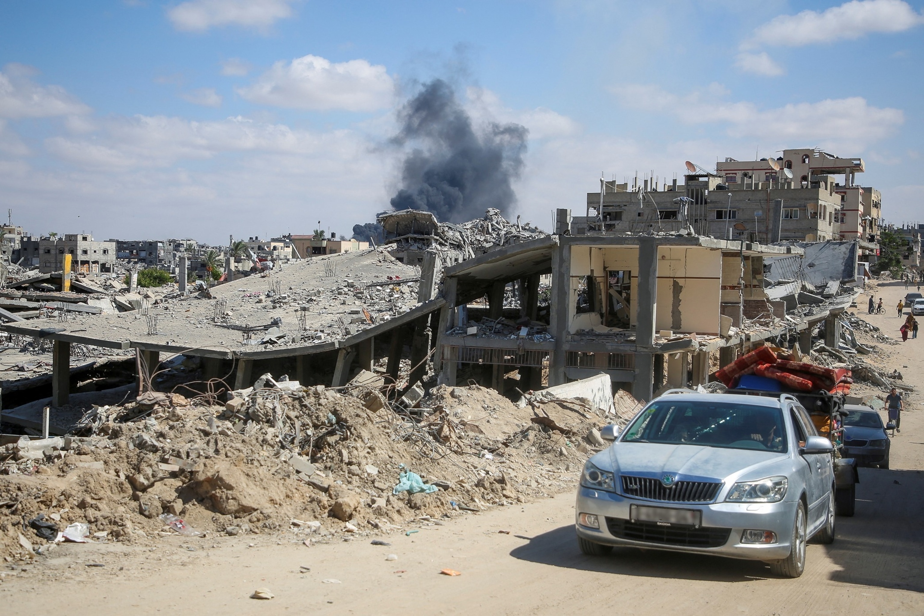 PHOTO: Smoke rises following an Israeli strike as displaced Palestinians make their way to flee areas in the eastern part of Khan Younis following an Israeli evacuation order, amid the ongoing conflict between Israel and Hamas, in Gaza, Oct. 7, 2024.