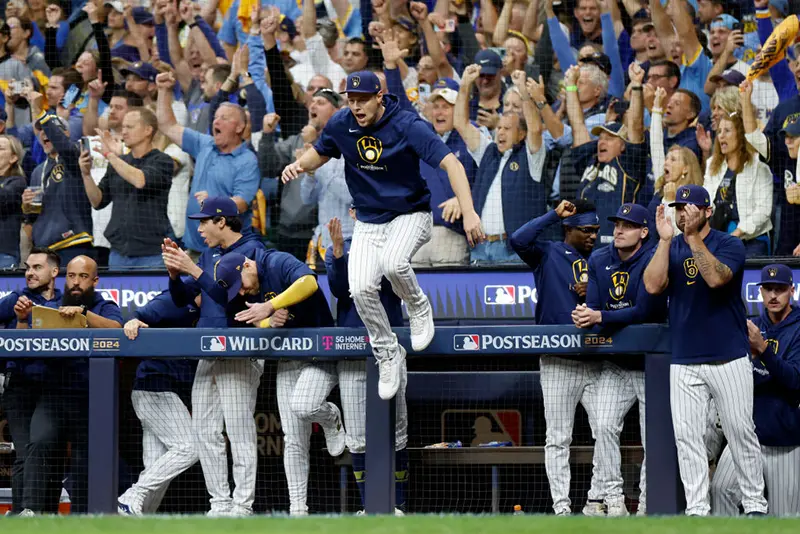 The Milwaukee Brewers celebrate after beating the New York Mets 5-3 in Game Two of the Wild Card Series at American Family Field on October 02, 2024 in Milwaukee, Wisconsin. (Photo by John Fisher/Getty Images)