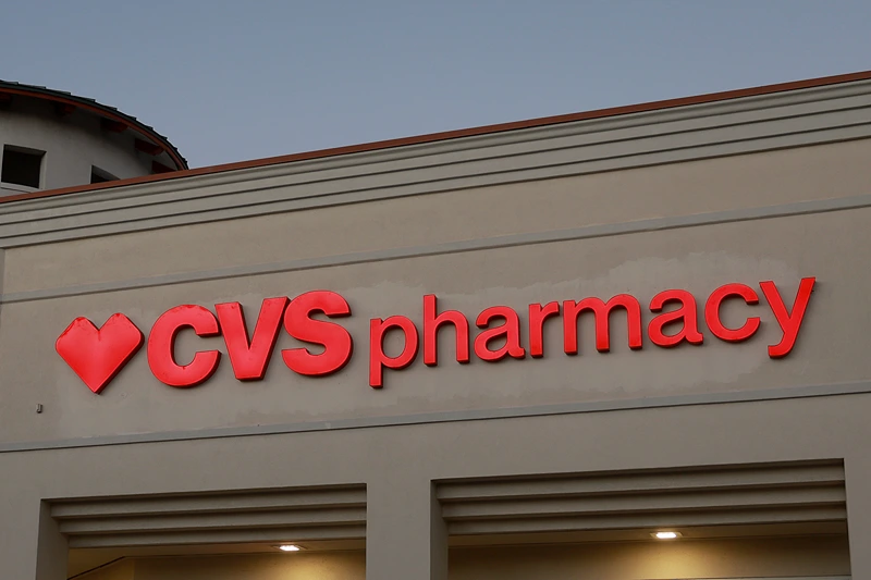 A sign outside of a CVS pharmacy store on February 07, 2024 in Miami, Florida. The company lowered its 2024 adjusted earnings forecast to at least $8.30 per share, down from a previous guidance of at least $8.50 per share. The company pointed to its medical cost trend analysis for the lower forecast. (Photo by Joe Raedle/Getty Images)