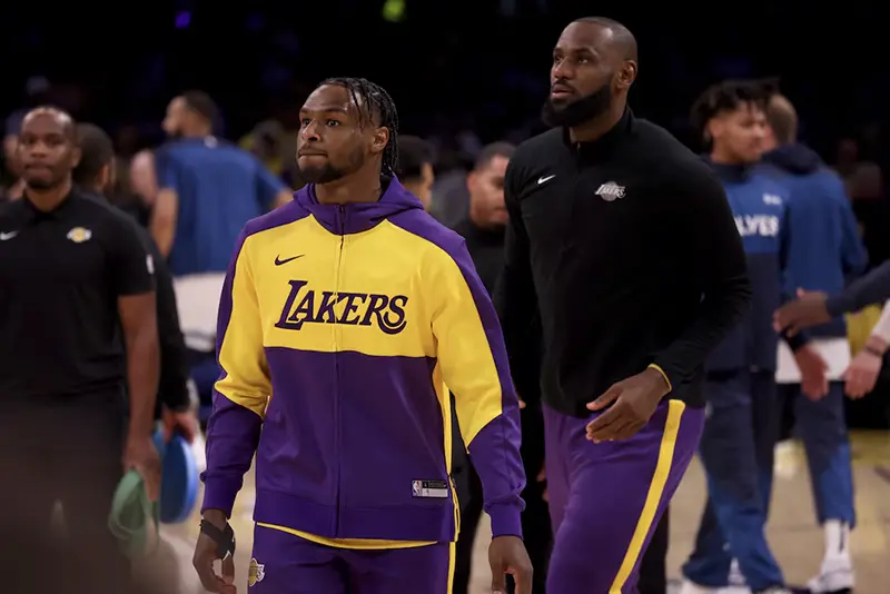 Los Angeles Lakers guard Bronny James (9) and forward LeBron James (23) warm up before a game against the Minnesota Timberwolves at Crypto.com Arena. Mandatory Credit: Jason Parkhurst-Imagn Images