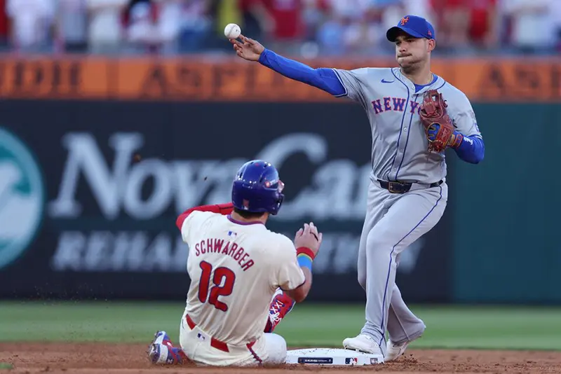 New York Mets second baseman Jose Iglesias (11) forces out Philadelphia Phillies designated hitter Kyle Schwarber (12) in the third inning in game one of the NLDS for the 2024 MLB Playoffs at Citizens Bank Park. Mandatory Credit: Bill Streicher-Imagn Images