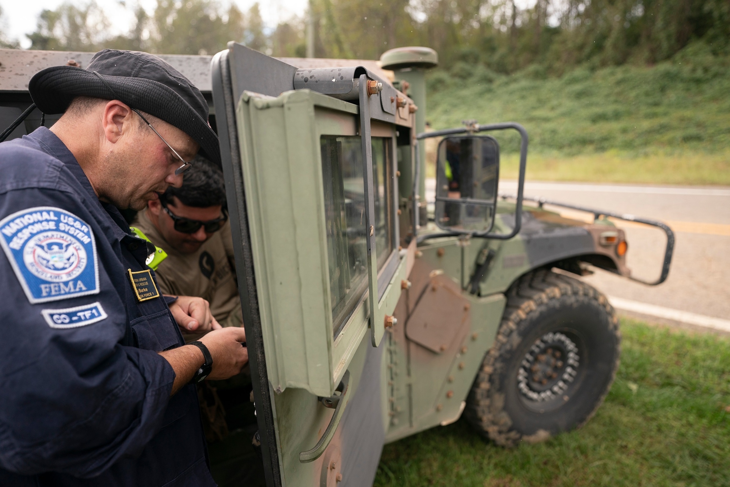 PHOTO: In this Sept. 30, 2024 file photo A FEMA response team member works with a guard member at Crooked Creek Fire Department near Old Fort in the aftermath of Hurricane Helene in Old Fort, N.C.