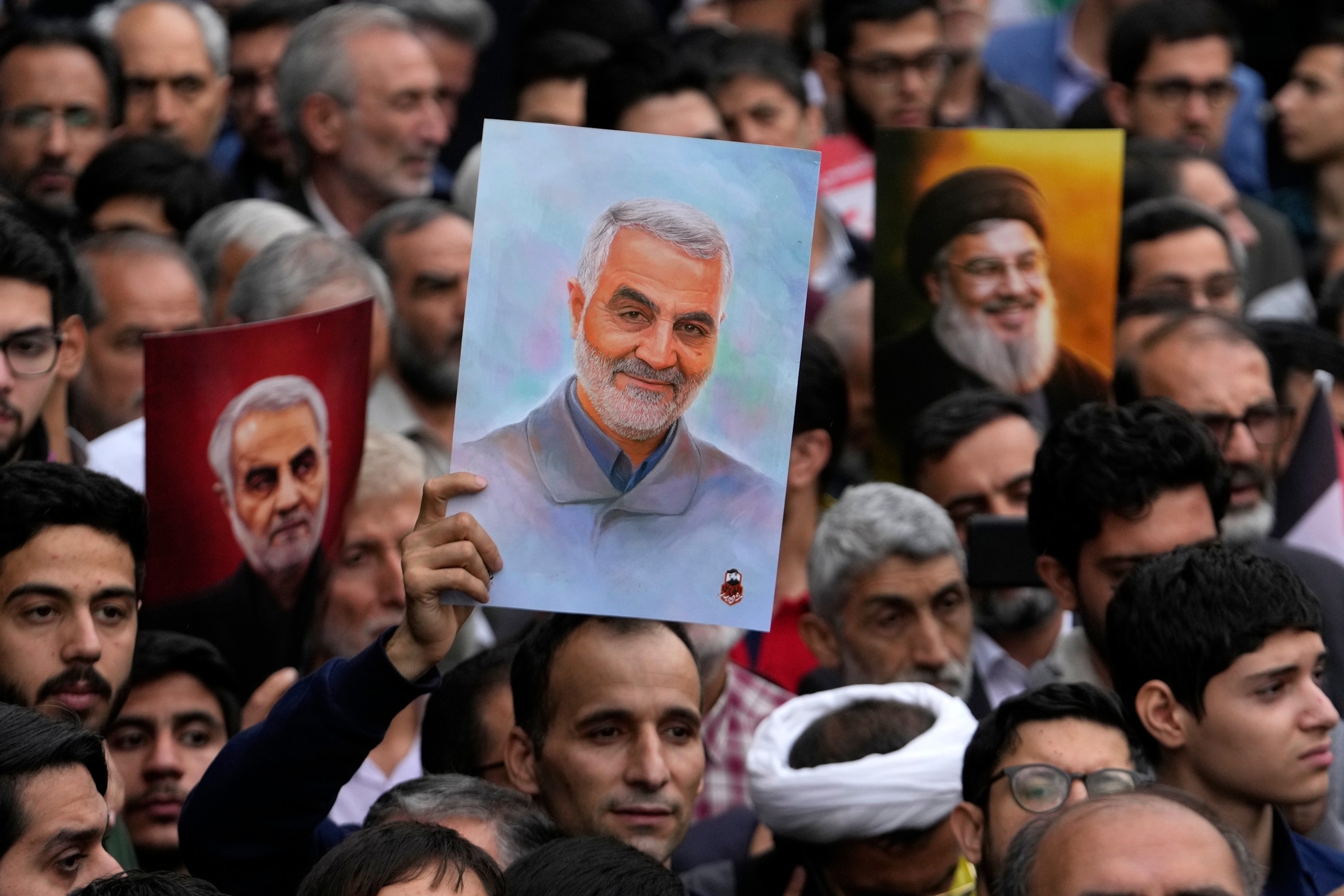 PHOTO: Iranian demonstrators hold up posters of the late Revolutionary Guard Gen. Qassem Soleimani, center who was killed in Iraq in a U.S. drone attack in 2020, during an annual rally in front of the former U.S. Embassy in Tehran, Iran, Nov. 3, 2024.