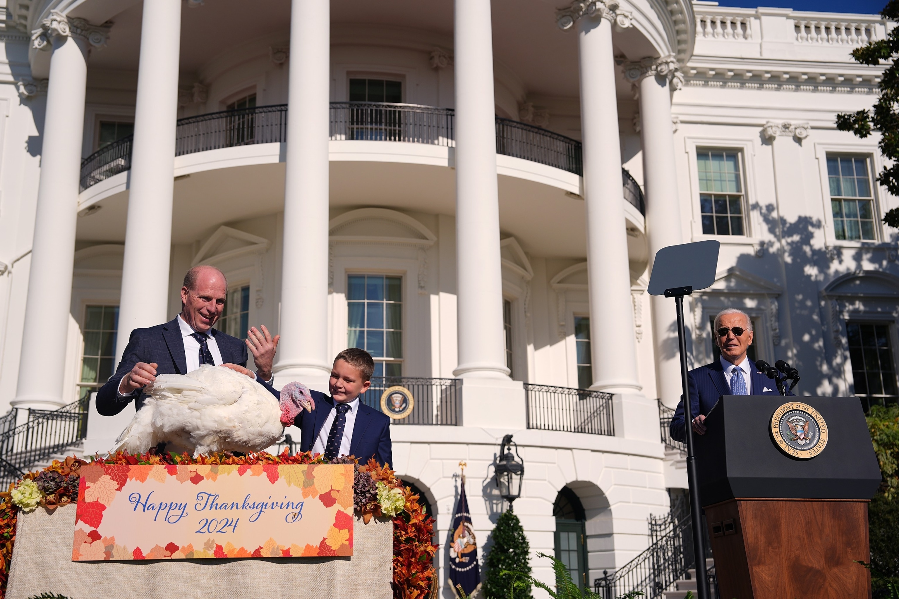 PHOTO: President Joe Biden (R) pardons the National Thanksgiving Turkey Peach alongside Chair of the national turkey federation John Zimmerman and his son Grant during a ceremony on the South Lawn of the White House on Nov. 25, 2024 in Washington, DC.