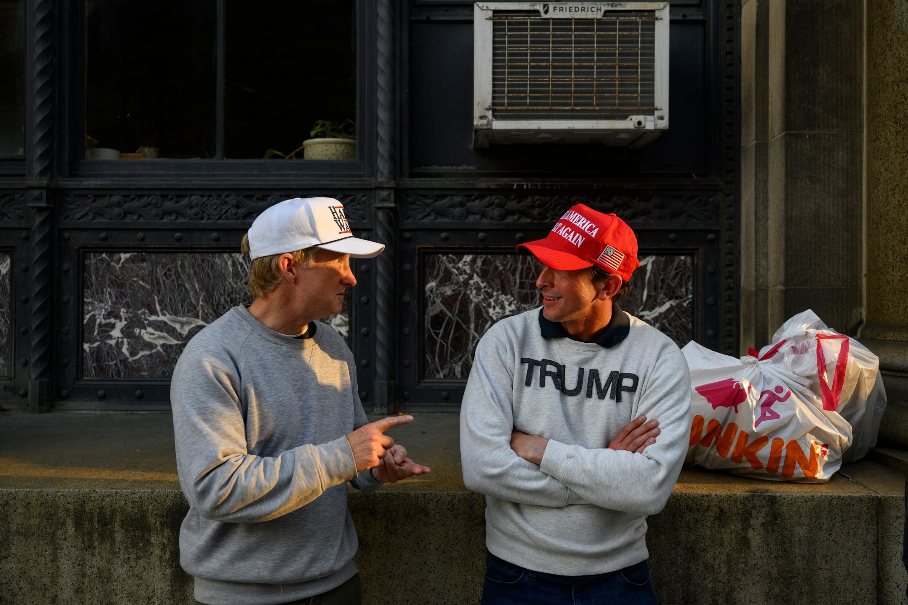 PHOTO: Supporters of both presidential candidates, Vice President Kamala Harris and former President Donald Trump, share a discussion outside the Allegheny County Office Building on Oct. 29, 2024 in Pittsburgh.