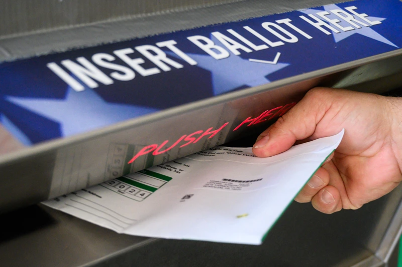 A voter uses a ballot drop box at the Bucks County Administration building voting on demand and ballot drop center in Doylestown, Pennsylvania on October 31, 2024. Kamala Harris clapped back Thursday at Donald Trump over what she called his "very offensive" remarks about women, returning reproductive rights to the fore as the rivals take their knife-edge White House race to western battleground states. (Photo by Ed JONES / AFP) (Photo by ED JONES/AFP via Getty Images)