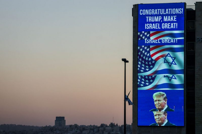 A large billboard congratulating US Republican presidential candidate and former president Donald Trump, is lit on the side of a building in Jerusalem on November 6, 2024. Israel's Prime Minister Benjamin Netanyahu on November 6 congratulated Donald Trump, who has won the US presidential election, calling it "history's greatest comeback" and a new beginning in the US-Israel alliance. (Photo by AHMAD GHARABLI / AFP) (Photo by AHMAD GHARABLI/AFP via Getty Images)