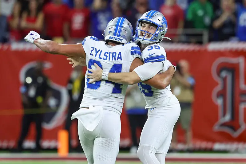 Detroit Lions place kicker Jake Bates (39) celebrates with tight end Shane Zylstra (84) after kicking a field goal with time expiring to give the Lions a win over the Houston Texans at NRG Stadium. Mandatory Credit: Troy Taormina-Imagn Images