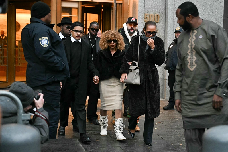 Sean "Diddy" Combs' mother Janice Combs (C) holds her grandson's Justin Dior Combs' hand (L) as they leave the federal court after Sean "Diddy" Combs' bail hearing on November 22, 2024 in New York City. (Photo by TIMOTHY A. CLARY / AFP) (Photo by TIMOTHY A. CLARY/AFP via Getty Images)