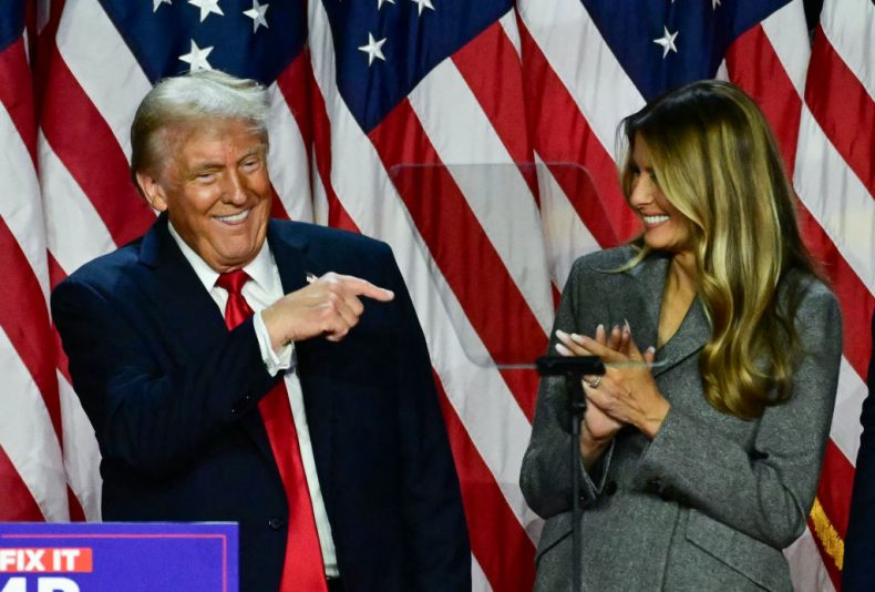 TOPSHOT - Former US President and Republican presidential candidate Donald Trump points to his wife former US First Lady Melania Trump during an election night event at the West Palm Beach Convention Center in West Palm Beach, Florida, early on November 6, 2024. (Photo by Jim WATSON / AFP) (Photo by JIM WATSON/AFP via Getty Images)