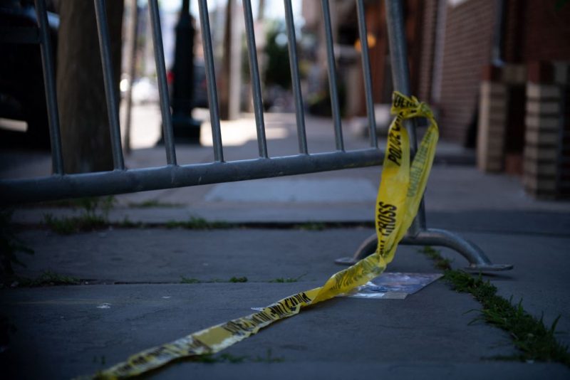 Police tape hangs from a barricade at the corner of Lombard and 4th Streets in Philadelphia, Pennsylvania, on June 5, 2022, the day after gunfire left three people dead and 11 others wounded. - Three people were killed and 11 others wounded late on June 4, 2022, in the US city of Philadelphia after multiple shooters opened fire into a crowd on a busy street, police said. (Photo by Kriston Jae Bethel / AFP) (Photo by KRISTON JAE BETHEL/AFP via Getty Images)