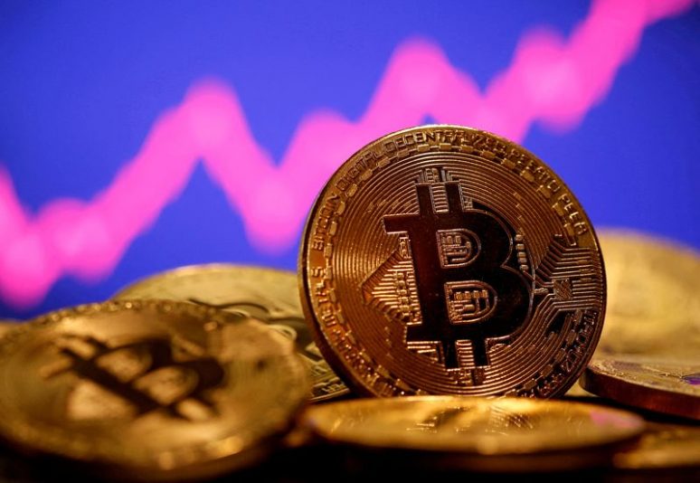 FILE PHOTO: A representation of virtual currency Bitcoin is seen in front of a stock graph in this illustration taken January 8, 2021. REUTERS/Dado Ruvic