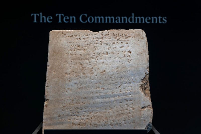 NEW YORK, NEW YORK - DECEMBER 09: The oldest known stone tablet inscribed with the Ten Commandments, dating from 300 to 800 A.D., is displayed at Sotheby's auction house on December 09, 2024 in New York City. The tablet will be sold in New York later this this month and is expected to be auctioned for $1 million to $2 million. Inscribed with the commandments in Paleo-Hebrew script, the tablet was discovered during railroad excavations along the southern coast of Israel in 1913. (Photo by Spencer Platt/Getty Images)