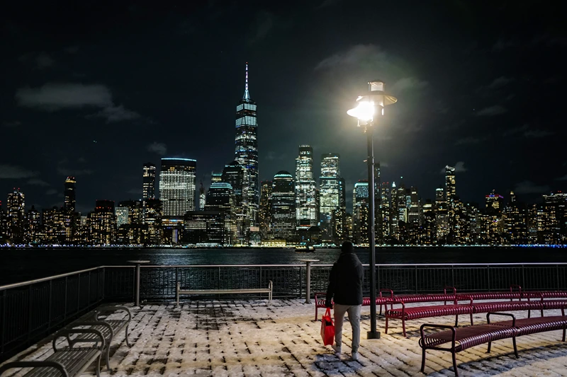 TOPSHOT - Night view of New York city's lower Manhattan skyline, with the One World Trade Center skyscraper (center left), seen from Jersey City on January 20, 2024. (Photo by Charly TRIBALLEAU / AFP) (Photo by CHARLY TRIBALLEAU/AFP via Getty Images)