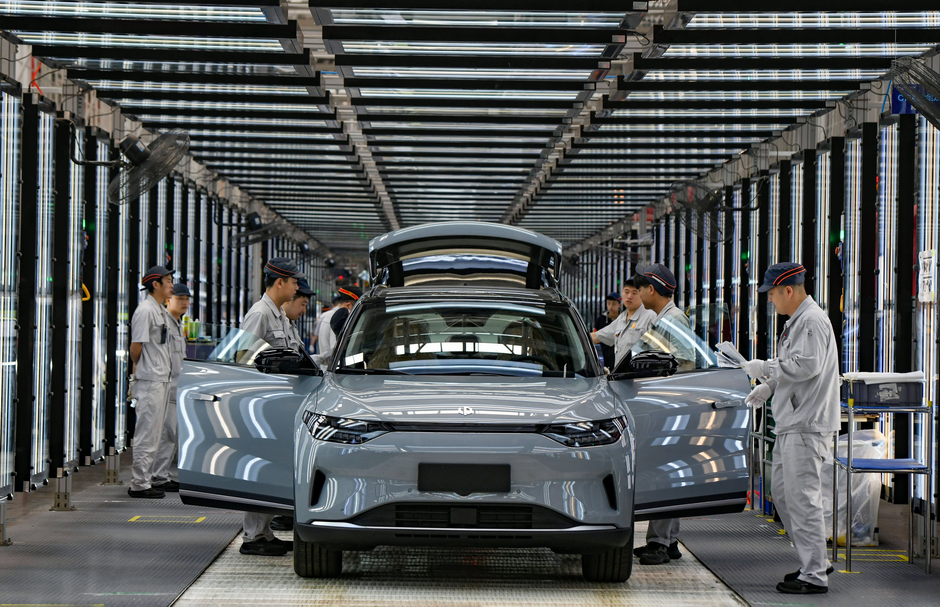 Employees work on the assembly line of new energy vehicles at a factory of Chinese EV startup Leapmotor on April 1, 2024 in Jinhua, Zhejiang Province of China.