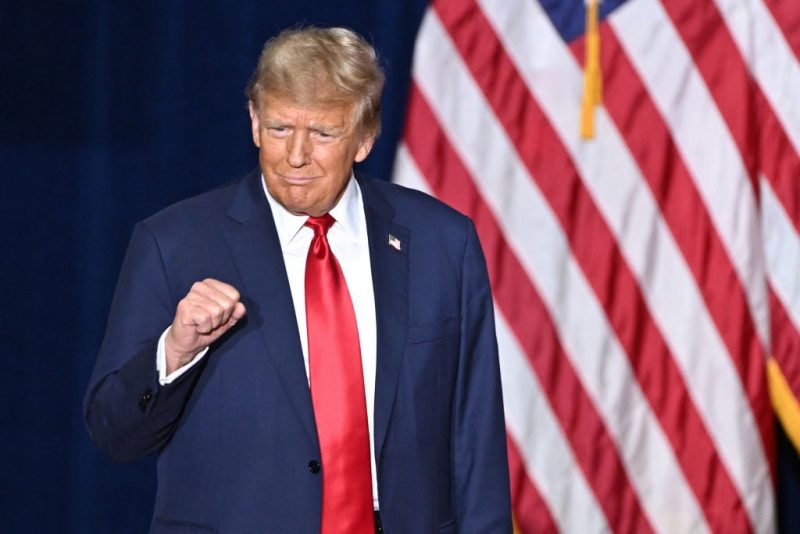 TOPSHOT - Former US President and Republican presidential hopeful Donald Trump arrives at a watch party during the 2024 Iowa Republican presidential caucuses in Des Moines, Iowa, on January 15, 2024. Trump told Americans Monday "it is time for our country to come together" after he won the Iowa caucuses, cementing his status as the likely Republican challenger to take on President Joe Biden in November's election. (Photo by Jim WATSON / AFP) (Photo by JIM WATSON/AFP via Getty Images)