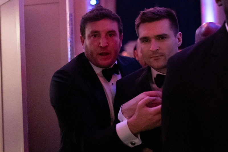 US political strategist Alex Bruesewitz (C) is escorted backstage after collapsing on stage while speaking during the New York Young Republican Club's Annual Gala at Cipriani's Wall Street in New York City on December 15, 2024. (Photo by Adam GRAY / AFP) (Photo by ADAM GRAY/AFP via Getty Images)