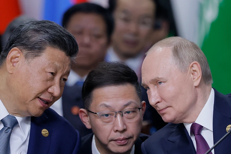 Russian President Vladimir Putin and Chinese President Xi Jinping speak during a plenary session in the outreach/BRICS Plus format at the BRICS summit in Kazan on October 24, 2024. (Photo by Maxim Shemetov / POOL / AFP) (Photo by MAXIM SHEMETOV/POOL/AFP via Getty Images)