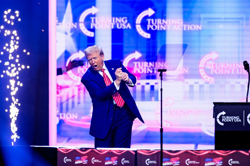 US President-elect Donald Trump mimics a golf swing onstage while speaking during Turning Point's annual AmericaFest 2024 in Phoenix, Arizona, on December 22, 2024. (Photo by JOSH EDELSON / AFP) (Photo by JOSH EDELSON/AFP via Getty Images)