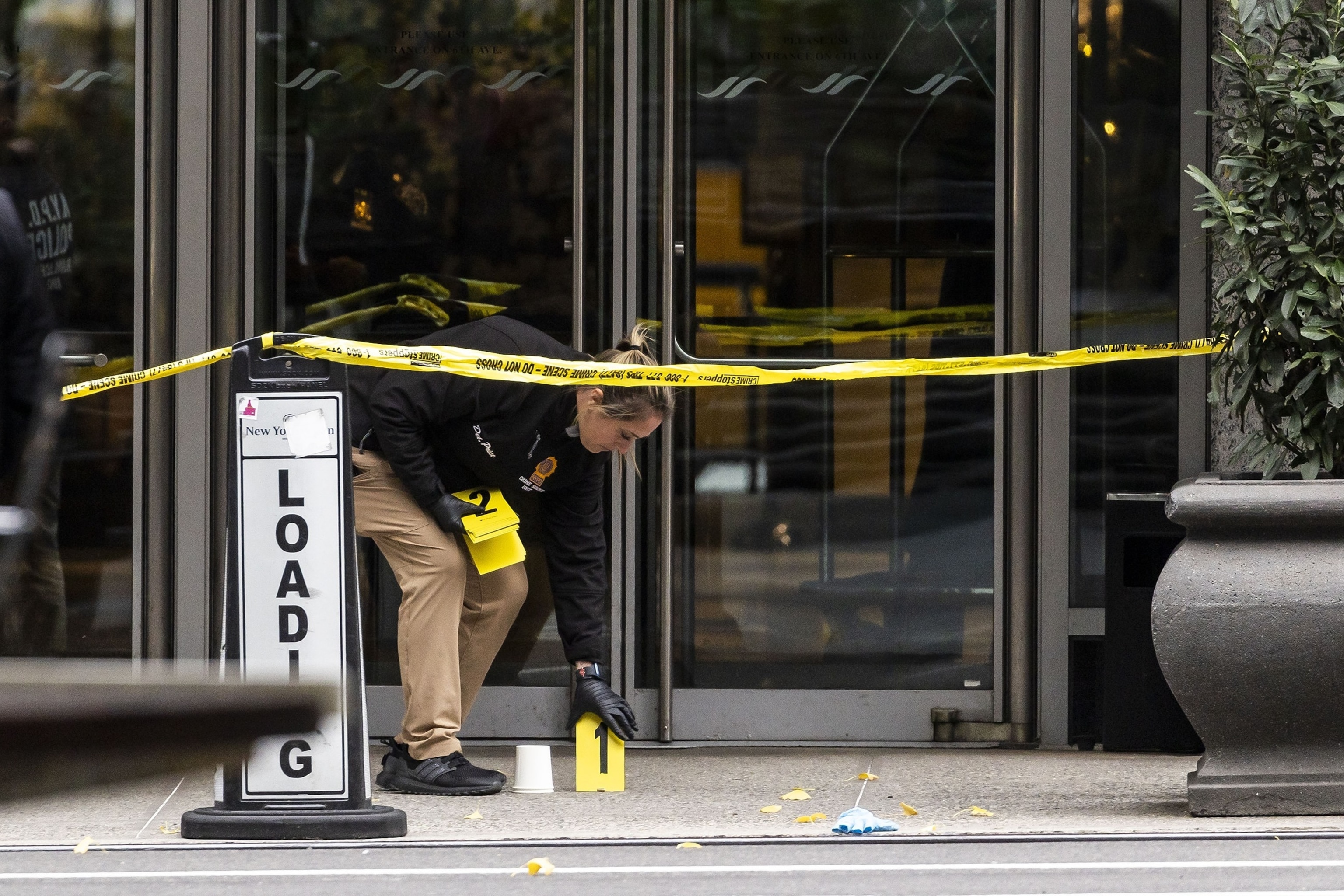 PHOTO: A member of the New York City police department's Crime Scene Unit at the scene where UnitedHealthcare's CEO Brian Thompson was shot and killed in in New York, Dec. 4, 2024.