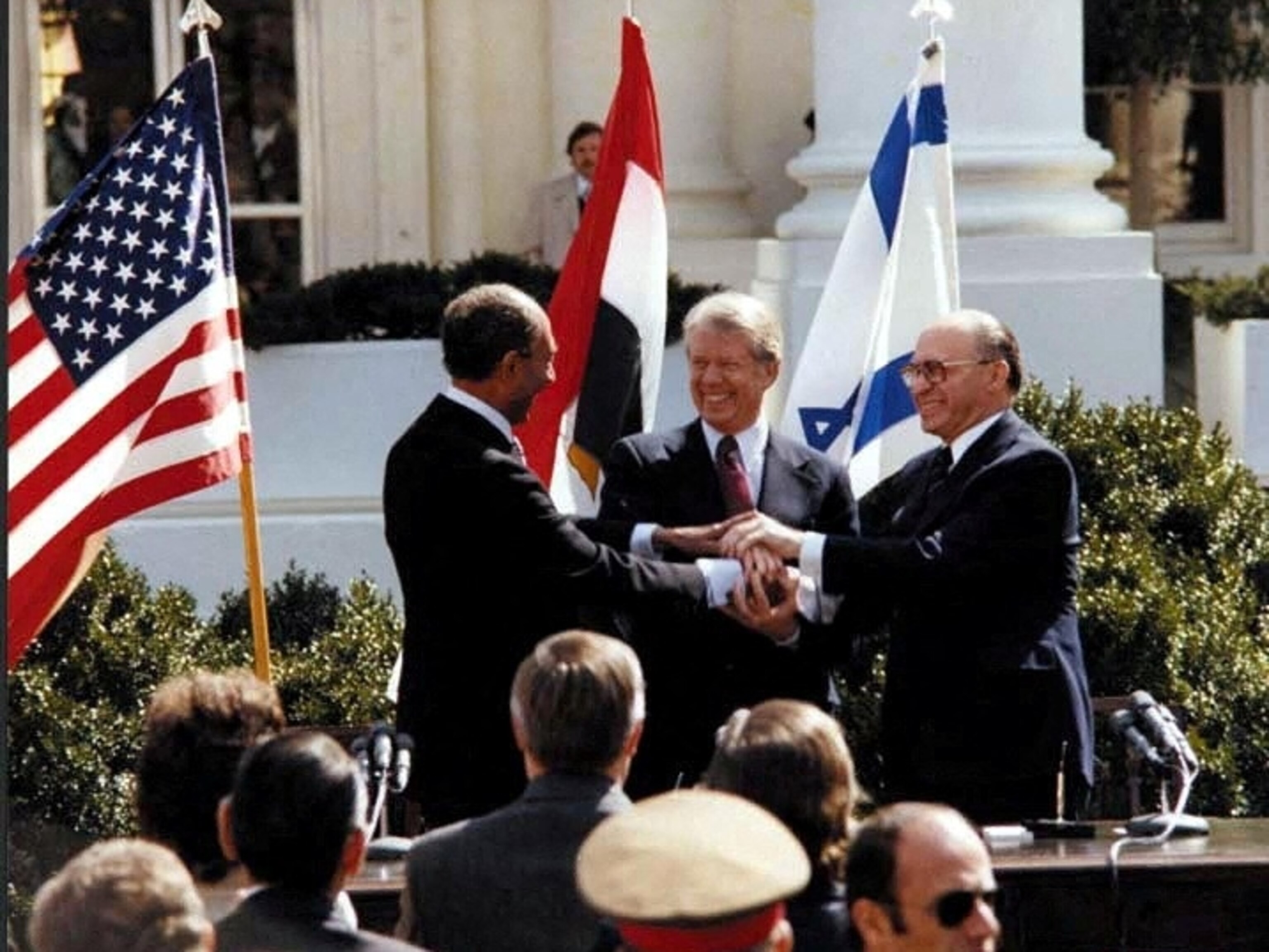 PHOTO: President Jimmy Carter, Egyptian President Anwar Sadat and Israeli Prime Minister Menachem Begin join hands in celebration of the signing of the 1979 Egyptian-Israeli peace treaty at the White House in Washington, D.C., on March 26, 1979.