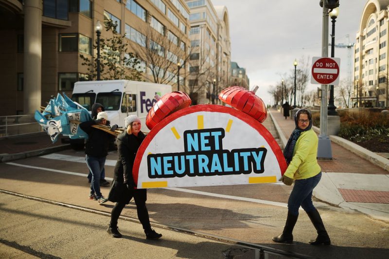 WASHINGTON, DC - DECEMBER 14: Rally organizers carry away props following a protest outside the Federal Communication Commission building against the end of net neutralityrules December 14, 2017 in Washington, DC. Lead by FCC Chairman Ajit Pai, the commission is expected to do away with Obama Administration rules that prevented internet service providers from creating different levels of service and blocking or promoting individual companies and organizations on their systems. (Photo by Chip Somodevilla/Getty Images)