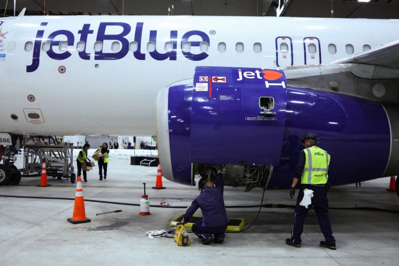 Employees of Jet Blue airlines work on an engine of an Airbus A320 passenger aircraft in a maintenance hangar of the company at JFK International Airport in New York on March 4, 2024, prior of a Career Discovery Week event. JetBlue and Spirit Airlines formally pulled the plug Monday on their merger, about six weeks after a federal judge ruled it violated US antitrust law. (Photo by Charly TRIBALLEAU / AFP) (Photo by CHARLY TRIBALLEAU/AFP via Getty Images)