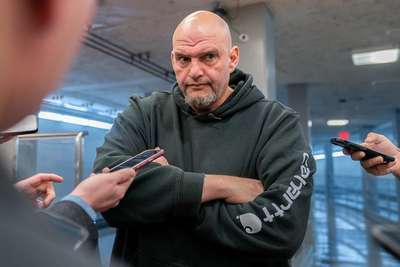 US Senator John Fetterman (D-PA) speaks to reporters as he goes to vote on the Laken Riley Act at the US Capitol in Washington, DC, on January 9, 2025. The Laken Riley Act -- which calls for the detention of undocumented immigrants charged with theft-related crimes -- is named for a 22-year-old student murdered by a Venezuelan man with no papers who was wanted for shoplifting. (Photo by Allison ROBBERT / AFP) (Photo by ALLISON ROBBERT/AFP via Getty Images)