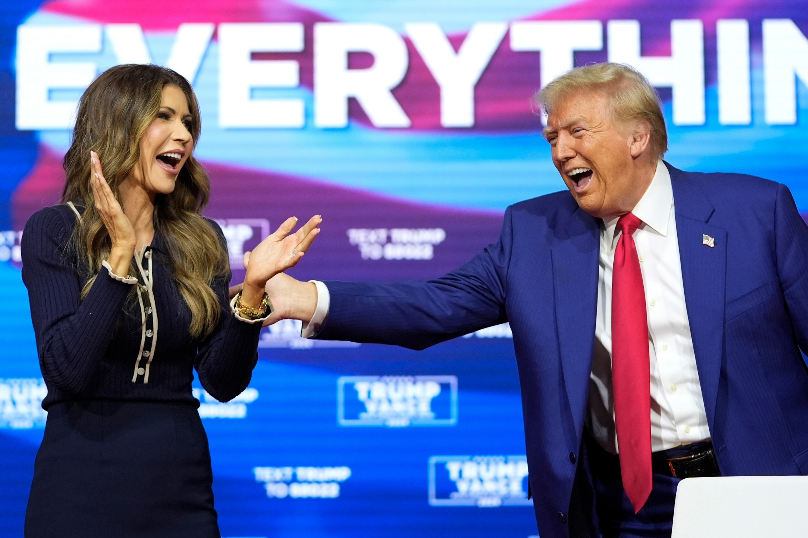 PHOTO: In this Oct. 14, 2024, file photo, Republican presidential nominee former President Donald Trump reacts with South Dakota Gov. Kristi Noem after dancing to the song "Y.M.C.A." at a campaign town hall in Oaks, Pa. 