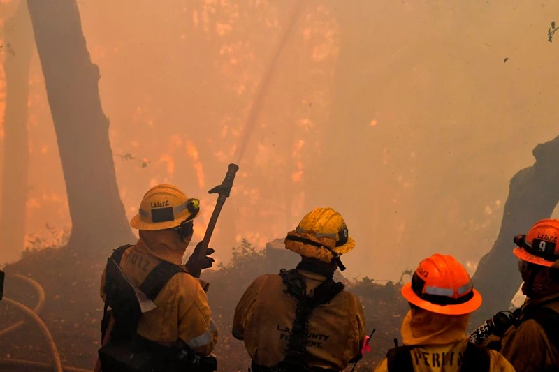 Firefighters work to protect a building at Mt. Wilson Observatory as the Bobcat Fire burns in the Angeles National Forest, northeast of Los Angeles, California on September 17, 2020. - The Bobcat Fire erupted on September 6 near the Cogswell Dam and West Fork Day Use area northeast of Mount Wilson within the Angeles National Forest, expanding from 46,263 acres to 50,539 acres since September 16 while remaining only 3% contained. (Photo by Frederic J. BROWN / AFP) (Photo by FREDERIC J. BROWN/AFP via Getty Images)