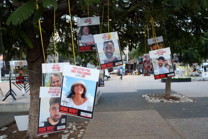 Pictures of Israeli captives hang from trees at the main gathering place of families of hostages held in the Gaza Strip since the October 7, 2023 attacks by Hamas militants, in Tel Aviv on January 16, 2025. Israel said on January 15 that several points in the Gaza ceasefire and hostage release deal still needed to be resolved but expected them to be finalised even as news spread that an agreement with Hamas had been reached. (Photo by Jack GUEZ / AFP) (Photo by JACK GUEZ/AFP via Getty Images)