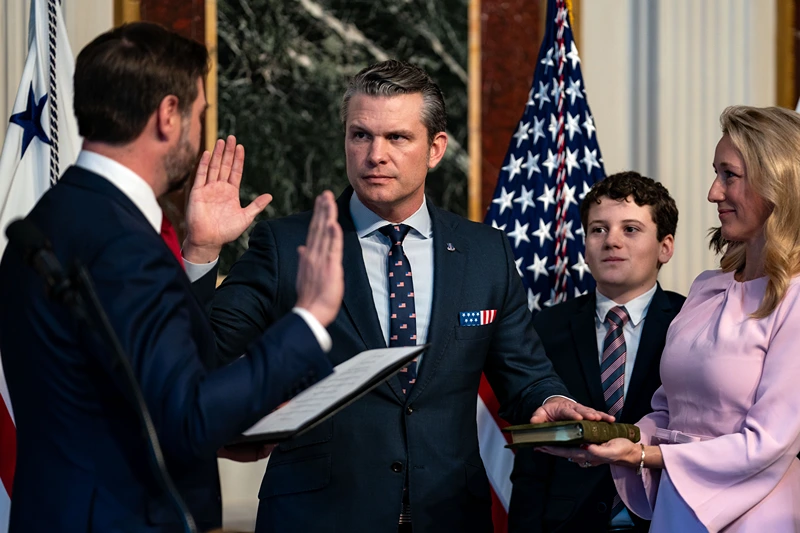 U.S. Vice President J.D. Vance (L) swears in Secretary of Defense Pete Hegseth alongside his wife Jennifer Rauchet in the Indian Treaty Room in the Eisenhower Executive Office Building on January 25, 2025 in Washington, DC. The Senate confirmed Pete Hegseth as Defense Secretary in a 51-50 vote, with Vice President J.D. Vance breaking the tie after three Republicans joined Democrats in opposition. It's only the second time in history that a vice president has broken a tie for a cabinet nominee. The first was Betsy DeVos in 2017. (Photo by Kent Nishimura/Getty Images)