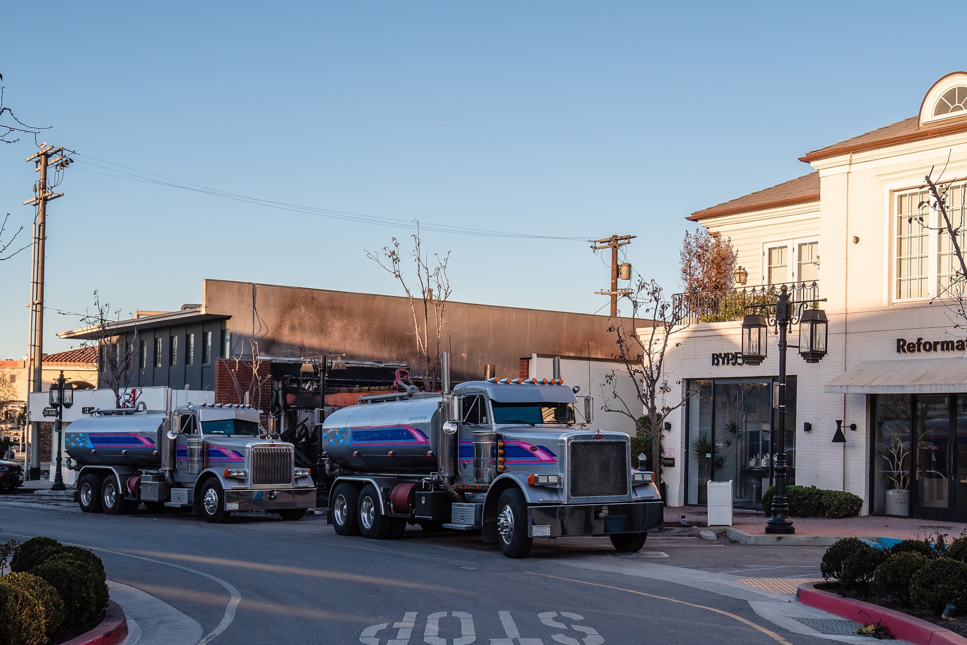 PHOTO: Water tankers at the Palisades Village shopping center in the Pacific Palisades area of Los Angeles, Jan. 12, 2025