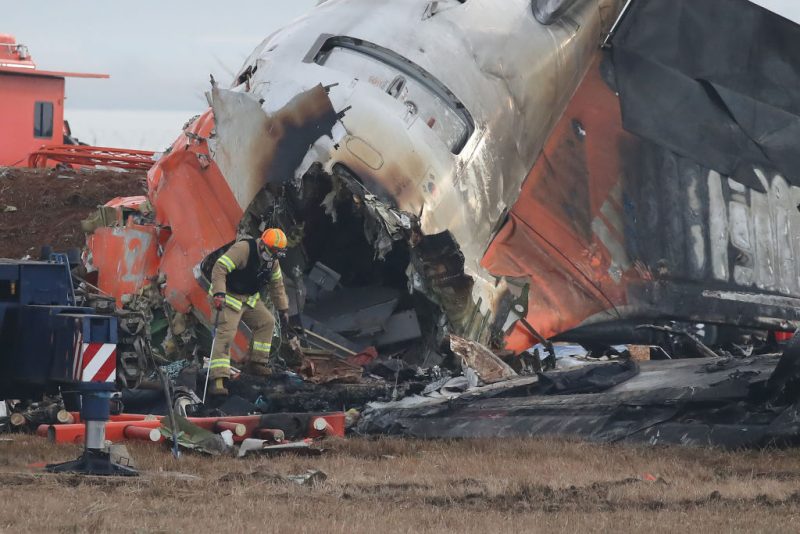 MUAN-GUN, SOUTH KOREA - DECEMBER 30: Firefighters work at the wreckage of a passenger plane at Muan International Airport on December 30, 2024 in Muan-gun, South Korea. A plane carrying 181 people, Jeju Air Flight 7C2216, crashed at Muan International Airport in South Korea after skidding off the runway and colliding with a wall, resulting in an explosion. Early reports said that at least 179 people had died. (Photo by Chung Sung-Jun/Getty Images)