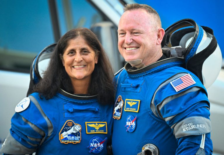 NASA astronauts Butch Wilmore (R) and Suni Williams, wearing Boeing spacesuits, depart the Neil A. Armstrong Operations and Checkout Building at Kennedy Space Center for Launch Complex 41 at Cape Canaveral Space Force Station in Florida to board the Boeing CST-100 Starliner spacecraft for the Crew Flight Test launch , on June 5, 2024. Boeing on June 5 will try once more to launch astronauts aboard a Starliner capsule bound for the International Space Station. Liftoff is targeted for 10:52 am (1452 GMT) for a roughly one-week stay at the orbital laboratory. (Photo by Miguel J. Rodriguez Carrillo / AFP) (Photo by MIGUEL J. RODRIGUEZ CARRILLO/AFP via Getty Images)