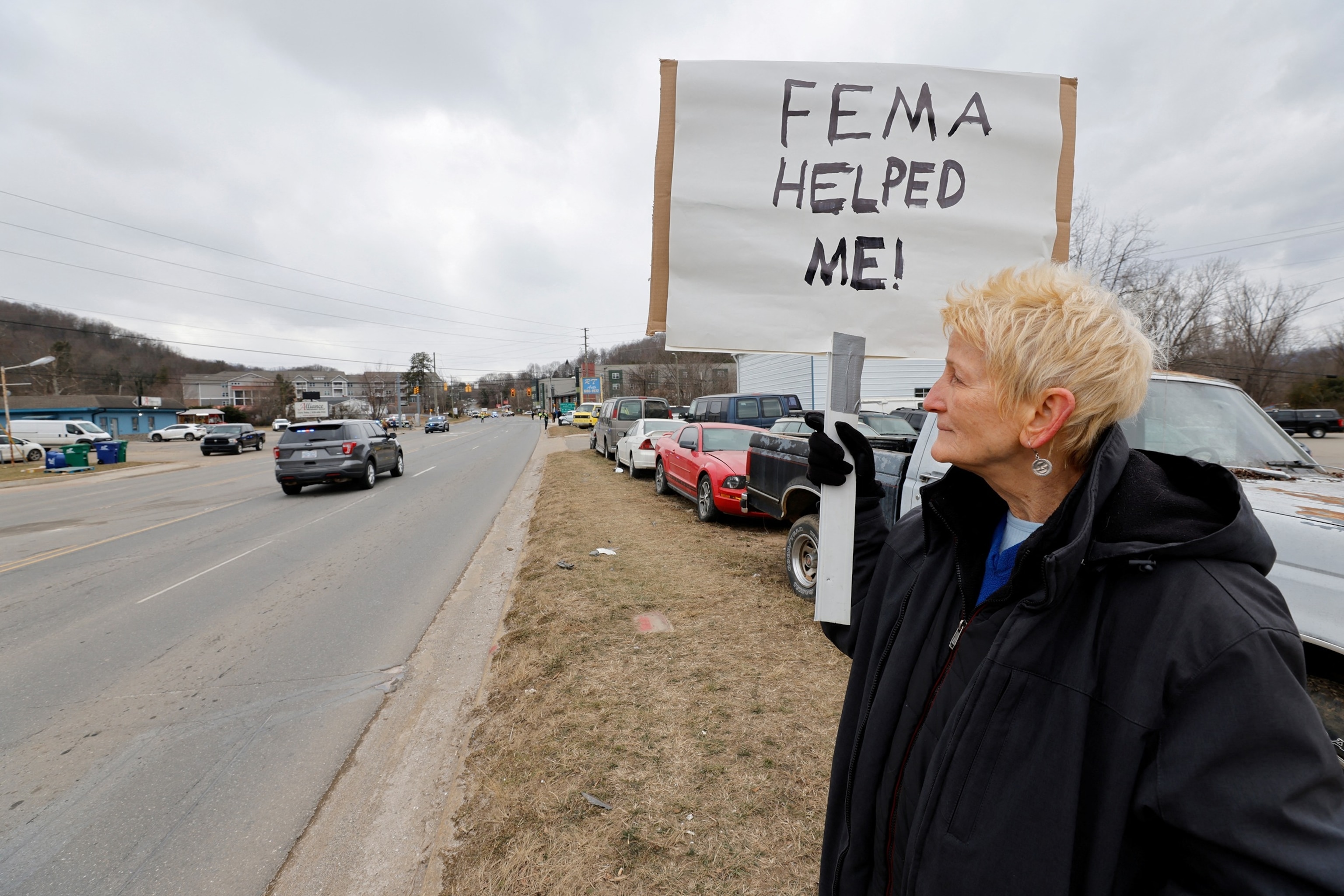 PHOTO: Swannanoa resident Lucy Bickers, who received assistance from FEMA after Hurricane Helene damaged her property waits on the route of visiting U.S. President Donald Trump's motorcade in Swannanoa, North Carolina, Jan. 24, 2025.