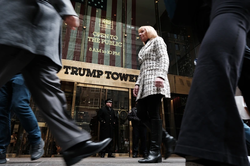 NEW YORK, NY - MARCH 31: People walk by Trump Tower the morning after former president Donald Trump was indicted by a New York jury on March 31, 2023 in New York City. Trump has been indicted for his role in a hush money scheme prior to the 2016 election. The vote to indict, which was brought by Manhattan District Attorney Alvin Bragg, suggests that a grand jury found probable cause that Trump committed an offense, which will now need to be proved to a jury. (Photo by Spencer Platt/Getty Images)